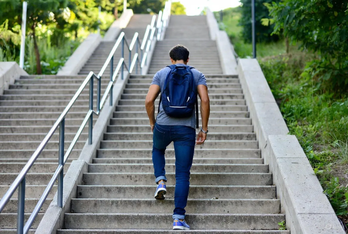 A Man Climbing Up A Long Stairs